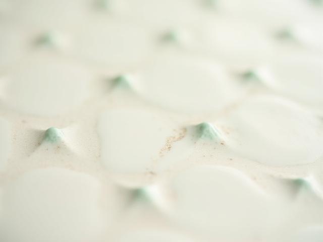 Custom textured ceramic tiles for spa walls.